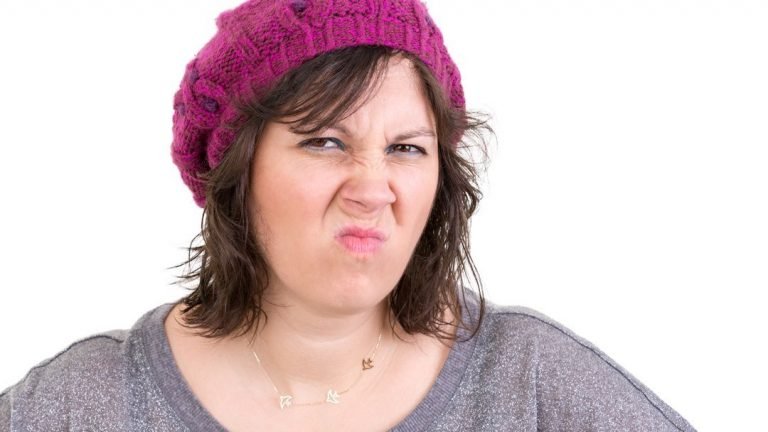 woman smelling cat urine and need some odor remover